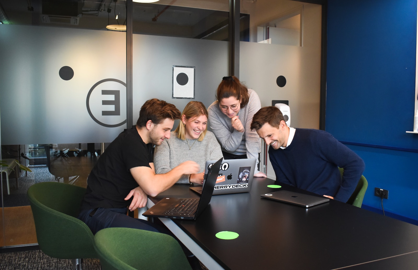 people sitting on chair in front of laptop computers checking their employee benefits