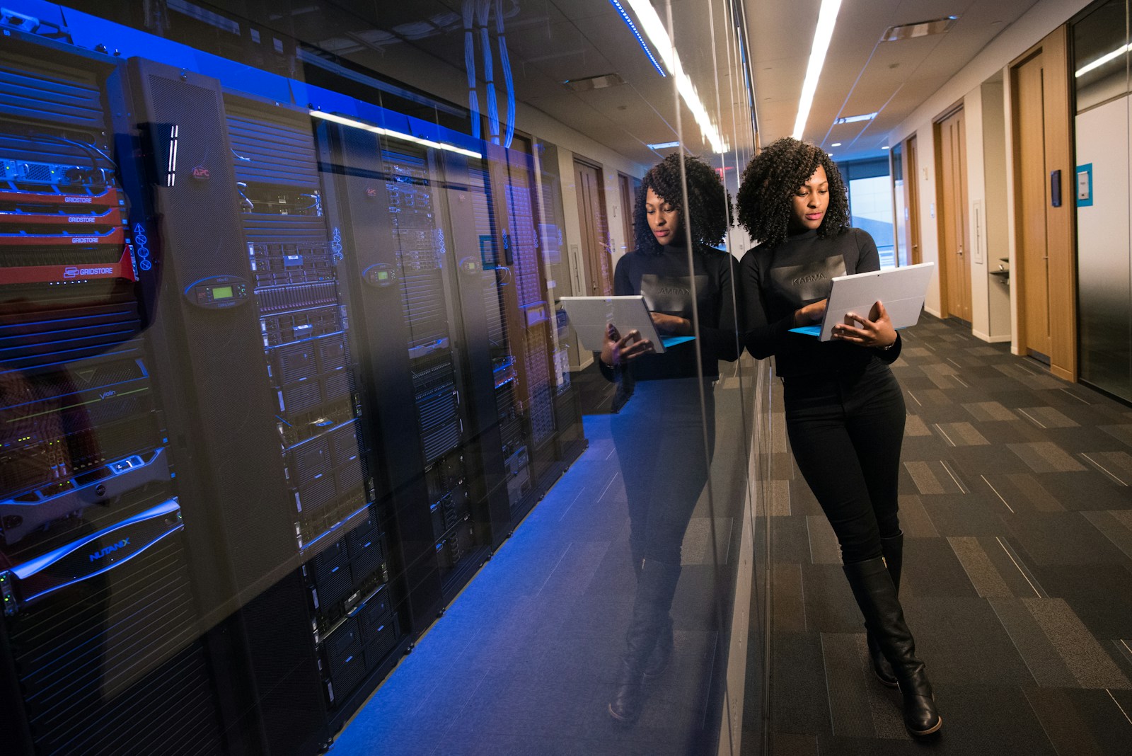 woman in black top with business insurance using Surface laptop